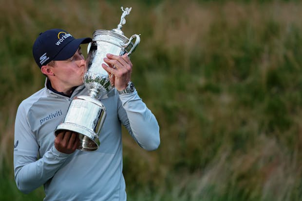Matt Fitzpatrick kisses the U.S. Open trophy after winning the 2022 tournament at The Country Club in Brookline, Massachusetts (by Patrick Smith/Getty Images)