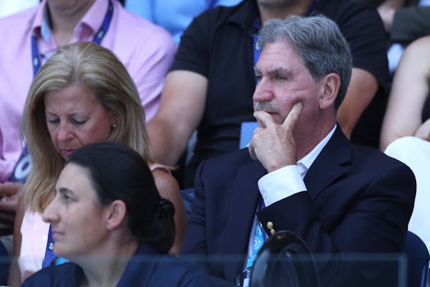 ITF president David Haggerty watches the fourth round singles match between Magda Linette and Caroline Garcia during the Australian Open (Photo by Clive Brunskill/Getty Images)