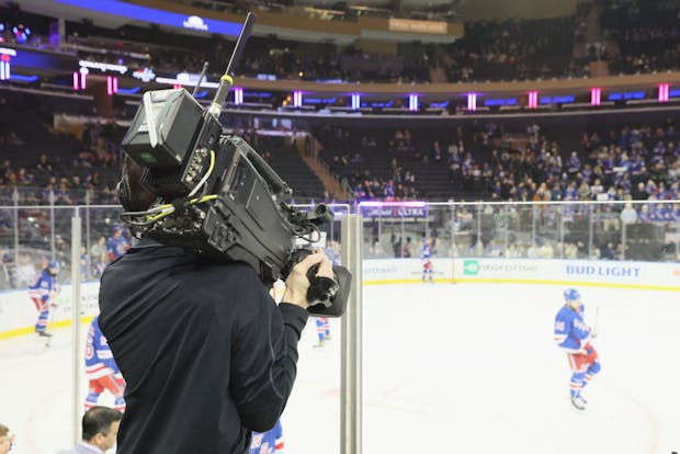 A TV cameraman at the NHL game between the New York Rangers and the Washington Capitals broadcast by ESPN on March 14, 2023 (by Bruce Bennett/Getty Images)