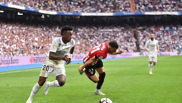 Vinicius Junior of Real Madrid dribbles the ball past Aitor Paredes of Athletic Club during the LaLiga match on June 4, 2023