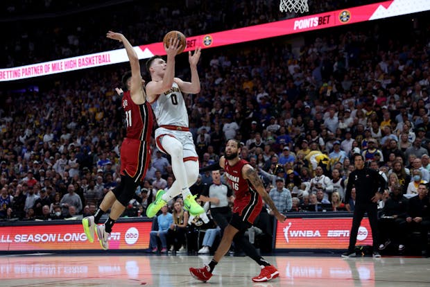 Christian Braun of the Denver Nuggets drives to the basket against the Miami Heat during Game Five of the 2023 NBA Finals (by Matthew Stockman/Getty Images)