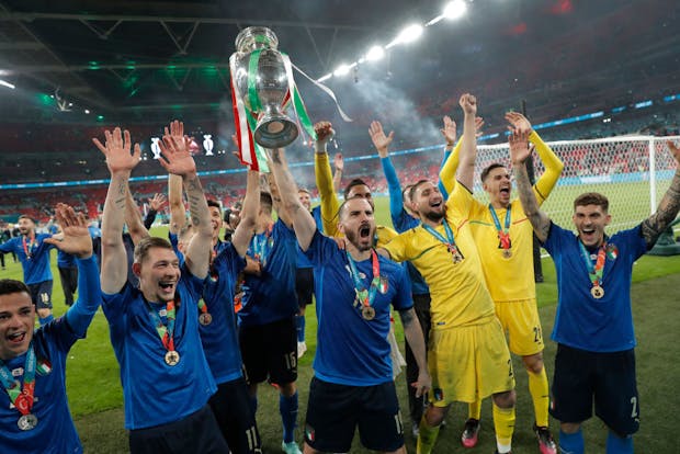Leonardo Bonucci lifts up the trophy as the Italian team celebrate victory after the Euro 2020 final (Photo by Tom Jenkins/Getty Images)