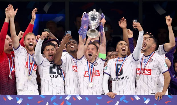 Toulouse celebrate victory during the trophy ceremony following the French Cup final against Nantes (Photo by Jean Catuffe/Getty Images)