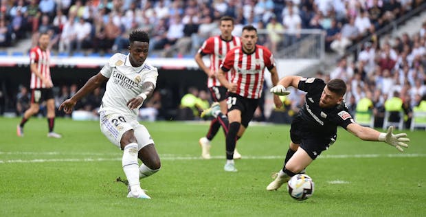 Vinicius Junior of Real Madrid shoots past Unai Simon of Athletic Club (Photo by Denis Doyle/Getty Images)