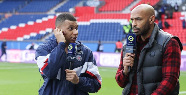 PSG's Kylian Mbappe speaks to Amazon Prime Video pundit Thierry Henry at Parc des Princes on February 19, 2023 in Paris. (Photo by Jean Catuffe/Getty Images)