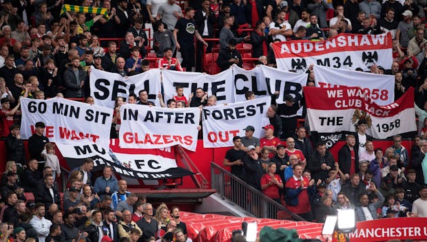MANCHESTER, ENGLAND - AUGUST 14: Manchester United fans hold up anti-Glazer banners against the owners of the club before the Premier League match between Manchester United and Wolverhampton Wanderers at Old Trafford on August 14, 2023 in Manchester, England. (Photo by