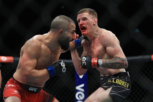 Jamie Mullarkey of Australia (R), trades punches with John Makdessi of Canada (L) during UFC 293