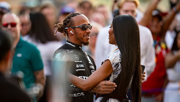 ABU DHABI, UNITED ARAB EMIRATES - NOVEMBER 26: Lewis Hamilton of Great Britain and Mercedes-AMG PETRONAS F1 Team and Naomi Campbell greet each other during the F1 Grand Prix of Abu Dhabi at Yas Marina Circuit on November 26, 2023 in Abu Dhabi, United Arab Emirates. (Photo by