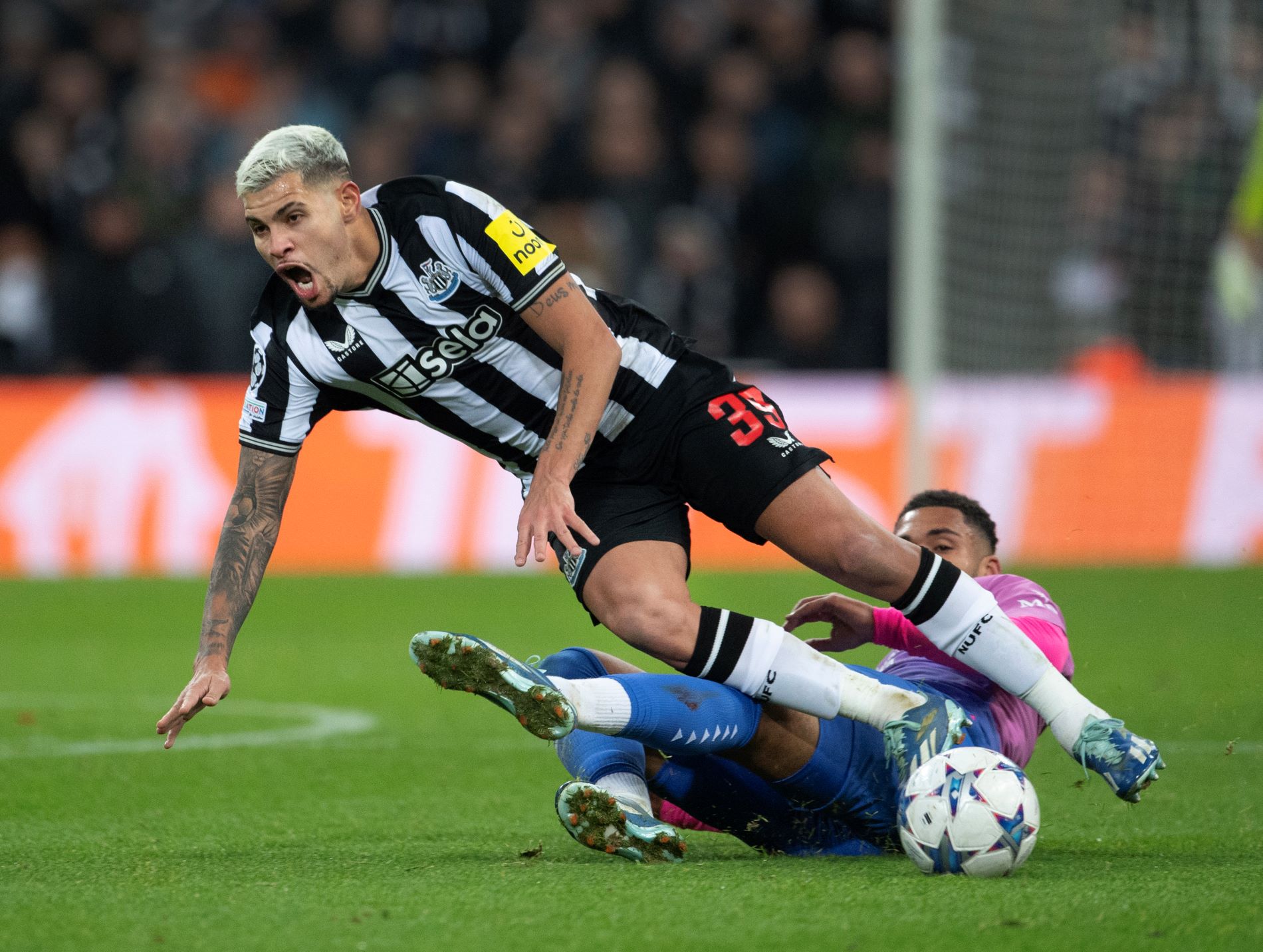 NEWCASTLE UPON TYNE, ENGLAND - DECEMBER 13: Bruno Guimaraes of Newcastle United and Ruben Loftus-Cheek of AC Milan in action during the UEFA Champions League match between Newcastle United FC and AC Milan at St. James Park on December 13, 2023 in Newcastle upon Tyne, England. (Photo by