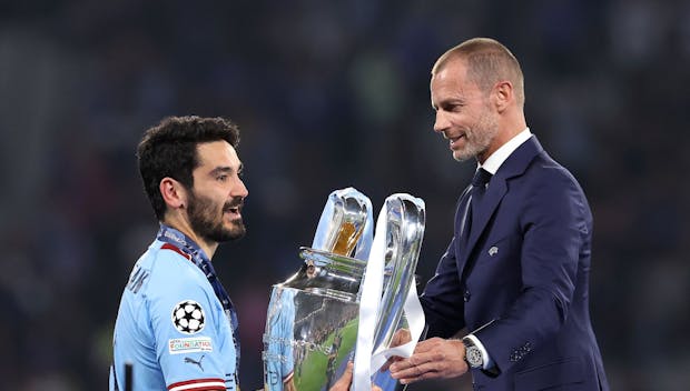 ISTANBUL, TURKEY - JUNE 10: Ilkay Gundogan of Manchester City is presented the Champions League Trophy by Aleksander Čeferin, Uefa President after winning the UEFA Champions League 2022/23 final match between FC Internazionale and Manchester City FC at Ataturk Olympic Stadium on June 10, 2023 in Istanbul, Turkey. (Photo by