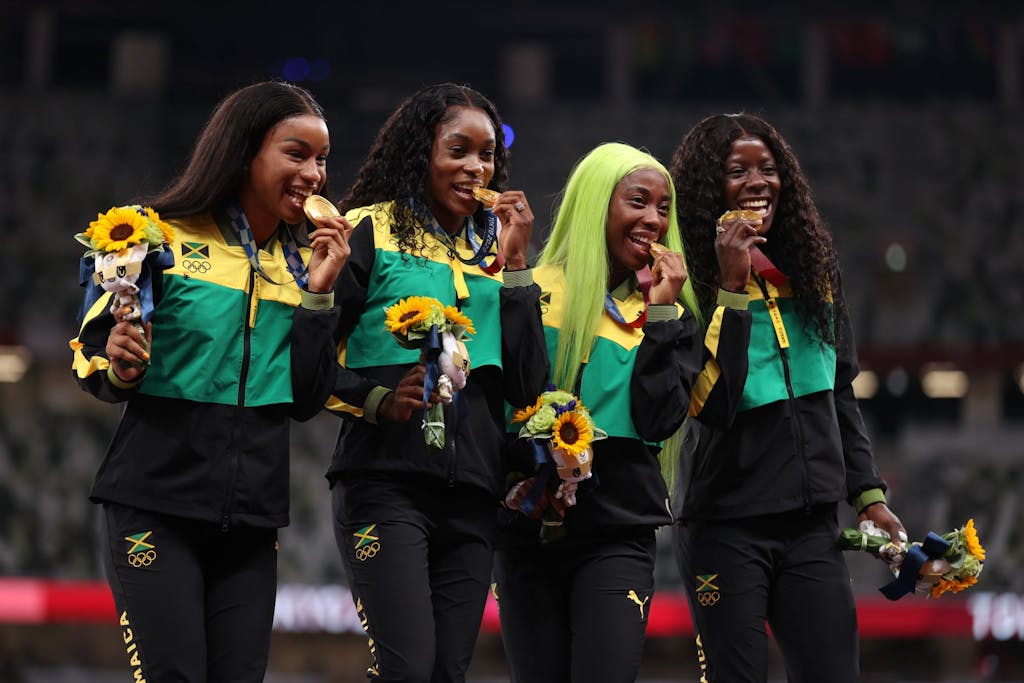 TOKYO, JAPAN - AUGUST 07: Gold medal winners Briana Williams, Elaine Thompson-Herah, Shelly-Ann Fraser-Pryce and Shericka Jackson of Team Jamaica stand on the podium during the medal ceremony for the Women’s 4 x 100m Relay on day fifteen of the Tokyo 2020 Olympic Games at Olympic Stadium on August 07, 2021 in Tokyo, Japan. (Photo by Christian Petersen/Getty Images)