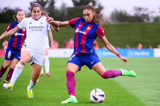 MADRID, SPAIN - MARCH 24: Salma Paralluelo of FC Barcelona (R) attempts a kick while is chased by Kenti Robles of Real Madrid CF Femenino (L) during Spanish Women's League F match between Real Madrid and FC Barcelona at Estadio Alfredo Di Stefano on March 24, 2024 in Madrid, Spain. (Photo by Alberto Gardin/Eurasia Sport Images/Getty Images)