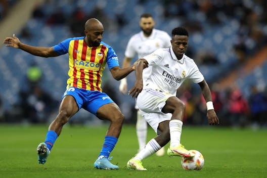 RIYADH, SAUDI ARABIA - JANUARY 11: Vinicius Junior of Real Madrid battles for possession with Dimitri Foulquier of Valencia CF during the Super Copa de Espana match between Real Madrid and Valencia CF at King Fahd International Stadium on January 11, 2023 in Riyadh, Saudi Arabia. (Photo by Yasser Bakhsh/Getty Images)