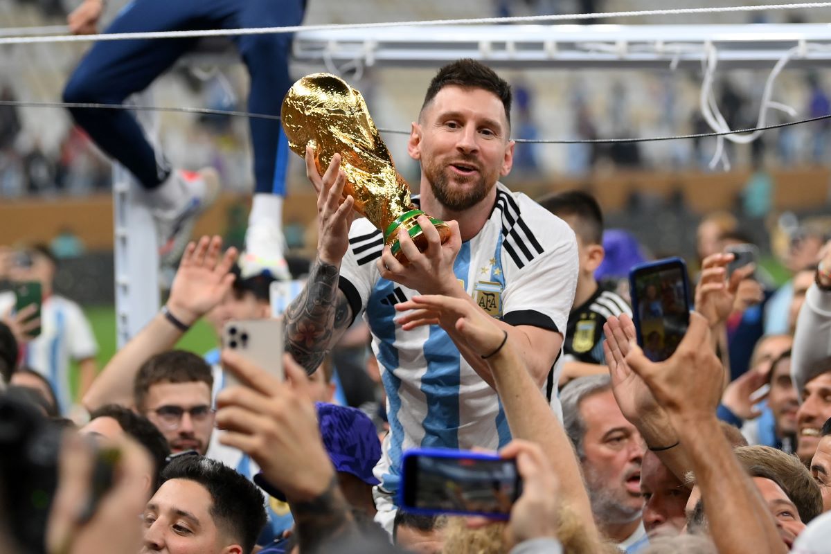 LUSAIL CITY, QATAR - DECEMBER 18: Lionel Messi of Argentina celebrates with the FIFA World Cup Qatar 2022 Winner's Trophy after the team's victory during the FIFA World Cup Qatar 2022 Final match between Argentina and France at Lusail Stadium on December 18, 2022 in Lusail City, Qatar. (Photo by Dan Mullan/Getty Images)
