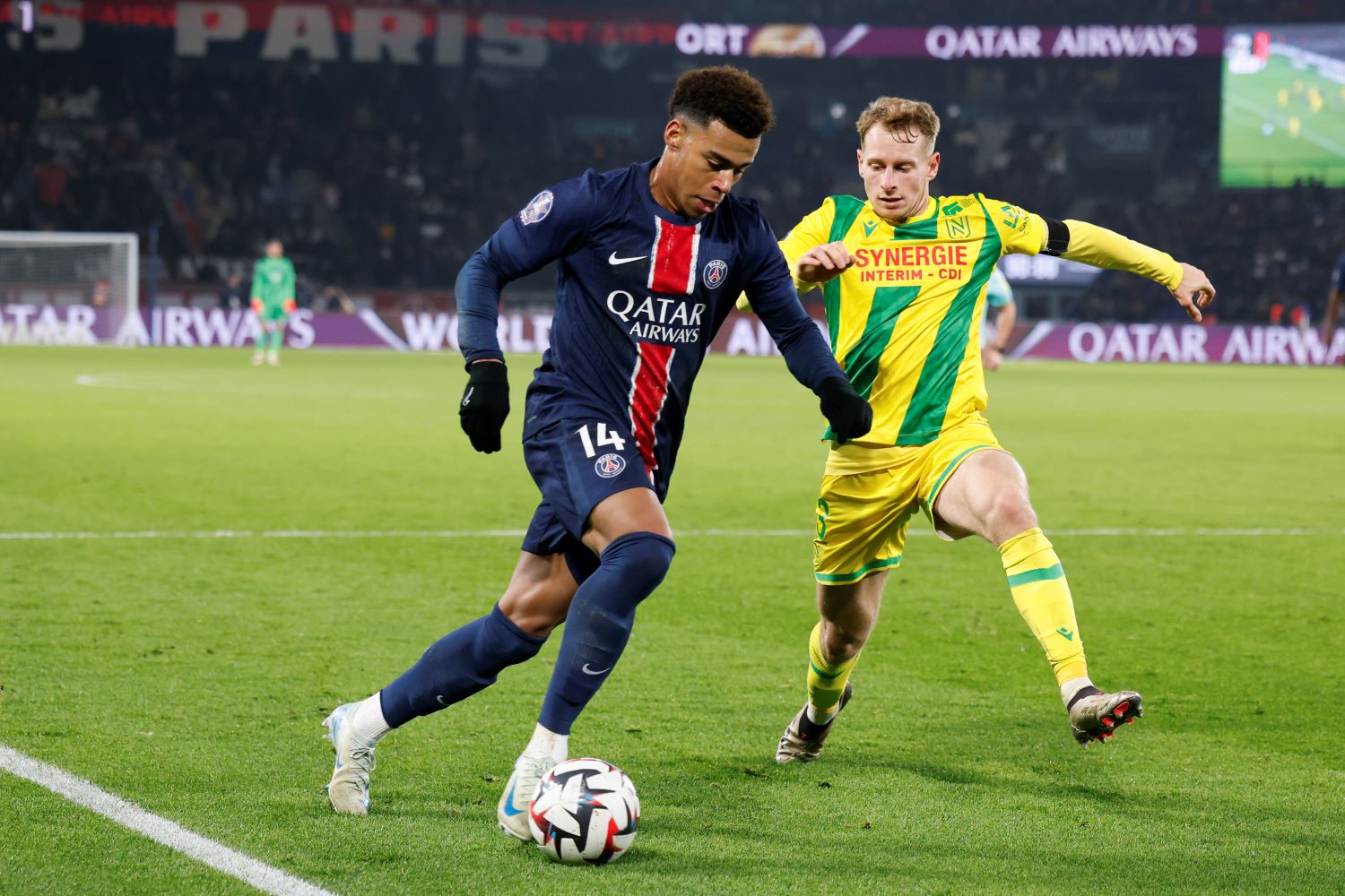 PARIS, FRANCE - NOVEMBER 30: Desire Doue #14 of Paris Saint-Germain controls the ball against Nicolas Cozza #3 of FC Nantes during the Ligue 1 match between Paris Saint-Germain and FC Nantes at Parc des Princes on November 30, 2024 in Paris, France. (Photo by Catherine Steenkeste/Getty Images for Qatar Airways)