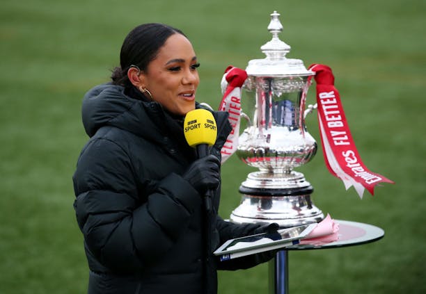 BBC Sport presenter Alex Scott stands next to FA Cup trophy (Photo by Alex Livesey/Getty Images)