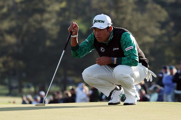 Hideki Matsuyama of Japan lines up a putt on the 18th green during the third round of The Masters (Photo by Gregory Shamus/Getty Images)