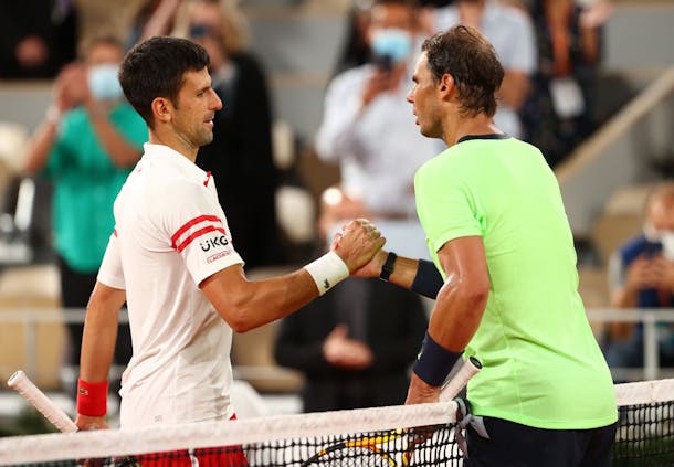 Novak Djokovic shakes hands with Rafael Nadal after winning their men's singles semi-final at the 2021 French Open (by Julian Finney/Getty Images)