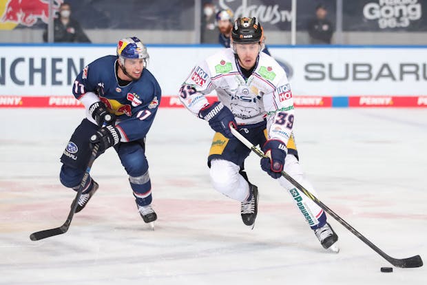 Johan Soedergran of Eisbaeren Berlin challenges Frederik Tiffels of EHC Red Bull Muenchen during the DEL Playoff Final Game 4 between EHC Red Bull Muenchen (Photo by Christian Kaspar-Bartke/Getty Images)