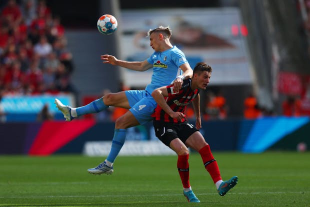 Nico Schlotterbeck of SC Freiburg battles for possession with Patrik Schick of Bayer 04 Leverkusen during the Bundesliga match on May 14, 2022 (by Dean Mouhtaropoulos/Getty Images)
