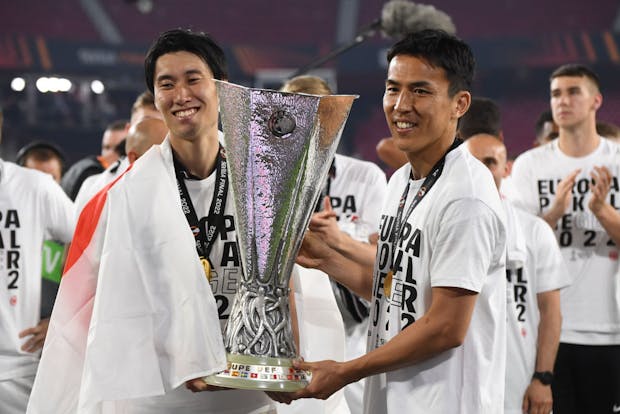Daichi Kamada and Makoto Hasebe of Eintracht Frankfurt lift the Europa League Cup,  May 2022 in Seville. (Photo by Kaz Photography/Getty Images)