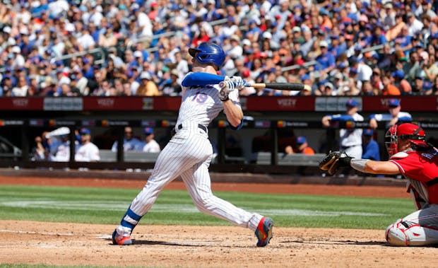 Mark Canha of the New York Mets follows through on a fourth inning RBI single against the Philadelphia Phillies on August 14, 2022 (by Jim McIsaac/Getty Images)