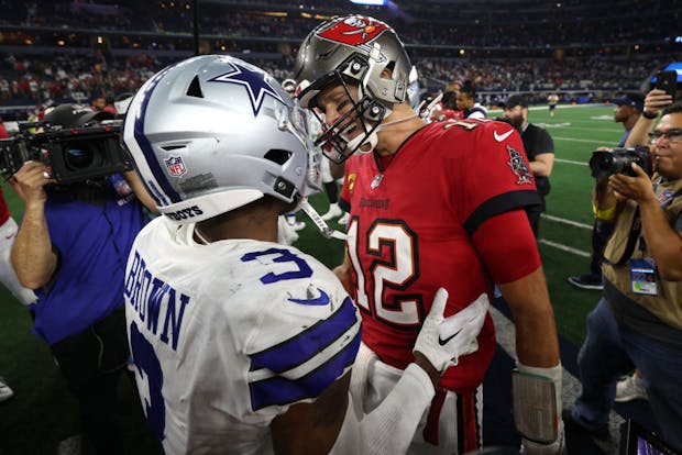 Anthony Brown (l) of the Dallas Cowboys talks with Tom Brady of Tampa Bay Buccaneers after their National Football League game on September 11, 2022. (Photo by Tom Pennington/Getty Images)