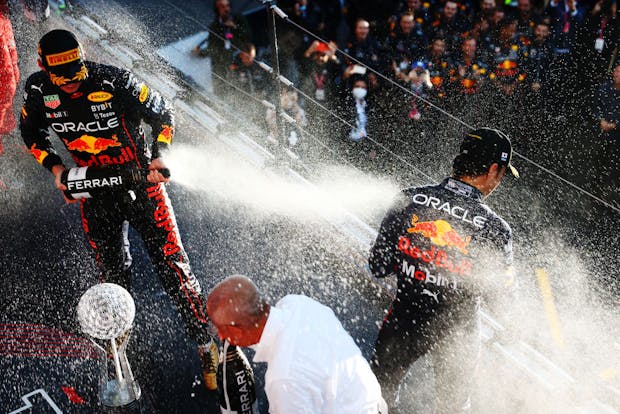 SUZUKA, JAPAN - OCTOBER 09: Max Verstappen and Sergio Perez celebrate on the podium.(Photo by Mark Thompson/Getty Images )