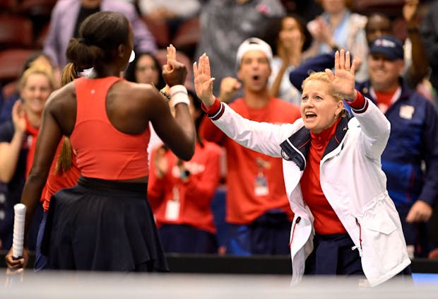 Captain Kathy Rinaldi high fives Asia Muhammad & Jessica Pegula of USA during Billie Jean King Cup Qualifier on April 16, 2022 (by Eakin Howard/Getty Images)