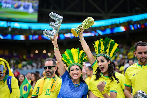 Fans of Brasil with a replica of the World Cup trophy at Lusail Stadium on November 24, 2022 (Photo by Markus Gilliar - GES Sportfoto/Getty Images)