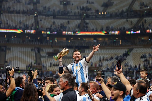 Lionel Messi of Argentina celebrates with the World Cup trophy (Photo by Marc Atkins/Getty Images)