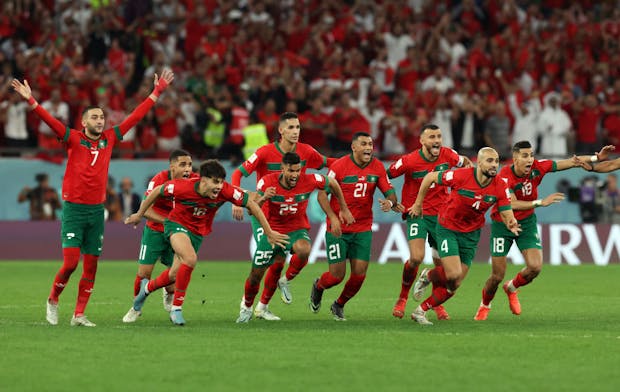 Morocco players run to congratulate Achraf Hakimi after he scores the winning penalty to defeat Spain in the 2022 Fifa World Cup Round of 16 match on December 6, 2022 (by Ian MacNicol/Getty Images)