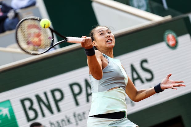 Zheng Qinwen plays a forehand in the women's singles fourth round match against Iga Swiatek during the 2022 French Open (by Shi Tang/Getty Images)