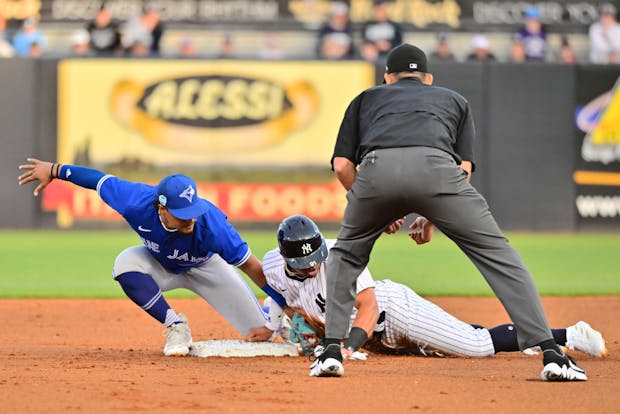 TAMPA, FLORIDA - MARCH 14: New York Yankees steals second base from Santiago Espinal of the Toronto Blue Jays. (Photo by Julio Aguilar/Getty Images)