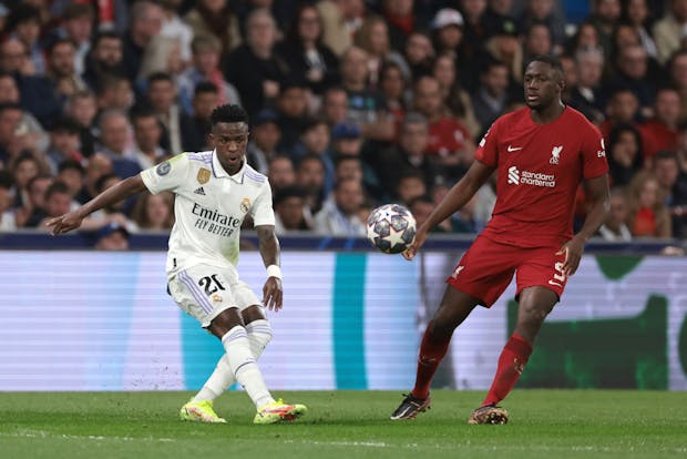 Vinicius Junior of Real Madrid passes the ball as Ibrahima Konate of Liverpool closes in (Photo by Jonathan Moscrop/Getty Images)