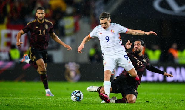 Emre Can of Germany challenges for the ball with Leandro Trossard of Belgium (Photo by Helge Prang - GES Sportfoto/Getty Images)