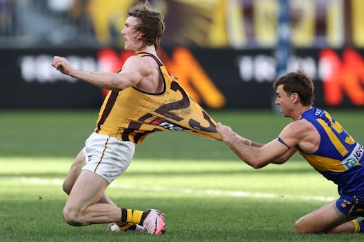 PERTH, AUSTRALIA - JUNE 30: Josh Weddle of the Hawks handpasses the ball under pressure from Jamie Cripps of the Eagles during the 2024 AFL Round 16 match between the West Coast Eagles and the Hawthorn Hawks at Optus Stadium on June 30, 2024 in Perth, Australia. (Photo by Will Russell/AFL Photos via Getty Images)
