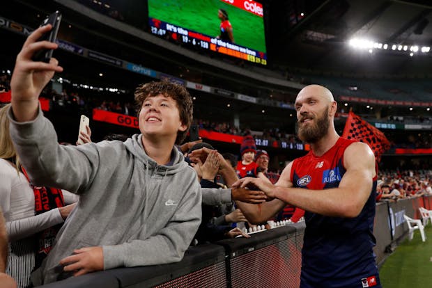 Max Gawn of the Melbourne Demons poses with fans at the Melbourne Cricket Ground. (Photo by Dylan Burns/AFL Photos via Getty Images)