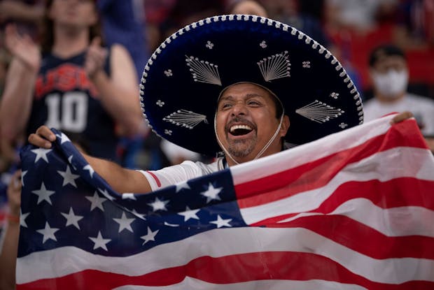 A fan in a sombrero waves a USA flag during the Fifa World Cup Qatar 2022 group stage match between England and USA. (Photo by Visionhaus/Getty Images).