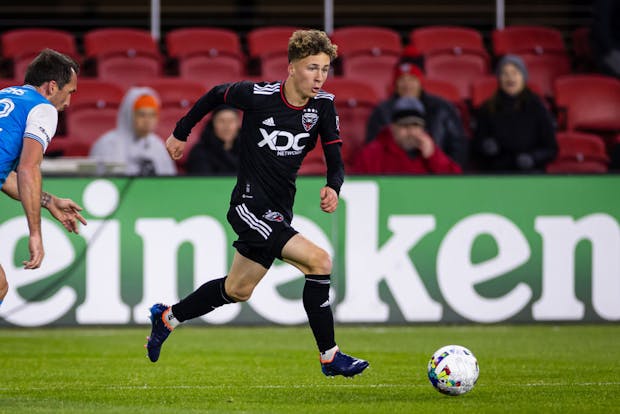Griffin Yow of DC United dribbles in front of a Heineken pitch-side sign during a match in 2022 (Getty Images)
