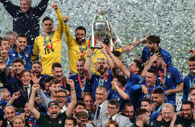 Leonardo Bonucci of Italy lifts the trophy and celebrates with team mates after the Uefa Euro 2020 final against England (by Marc Atkins/Getty Images)