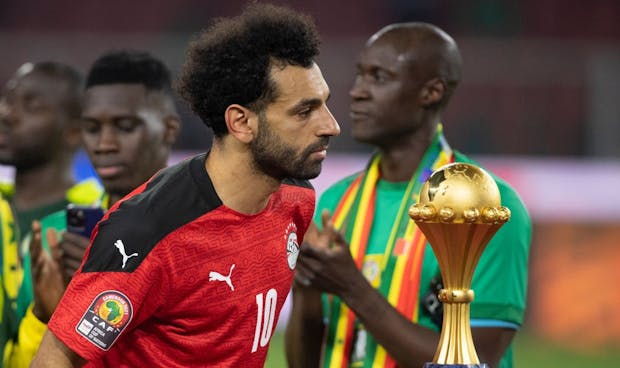 Mohamed Salah of Egypt walks past the AFCON trophy after losing 2021 final to Senegal (Photo by Visionhaus/Getty Images)