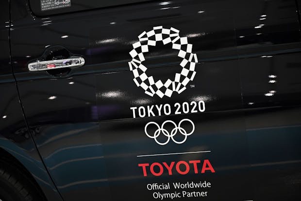 An Olympics games logo is seen on a displayed car at Toyota showroom in Tokyo on November 6, 2020. (Photo by Philip FONG / AFP) (Photo by PHILIP FONG/AFP via Getty Images)