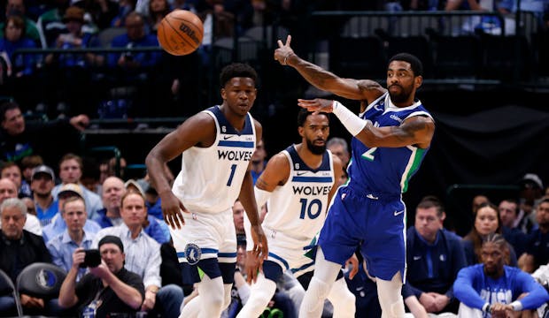 Kyrie Irving of the Dallas Mavericks makes a pass against the Minnesota Timberwolves (Photo by Ron Jenkins/Getty Images)
