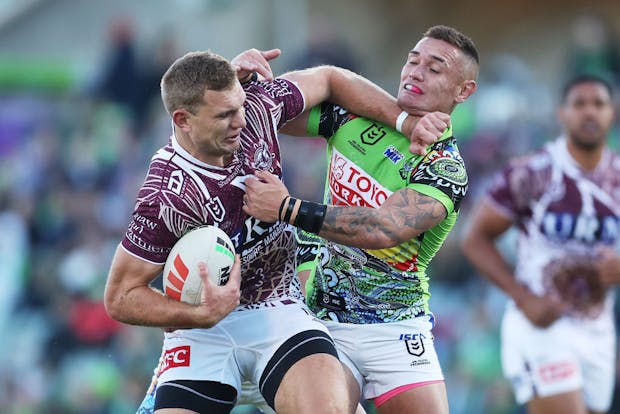 Tom Trbojevic of the Manly Sea Eagles is tackled during the round 12 NRL match versus Canberra Raiders on May 21, 2023 (by Mark Metcalfe/Getty Images)