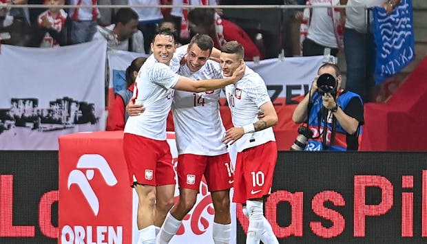 Poland's Kiwior, Zielinski & Szymanski celebrate scoring in  international friendly v Germany on June 16, 2023. (Photo by PressFocus/MB Media/Getty Images)