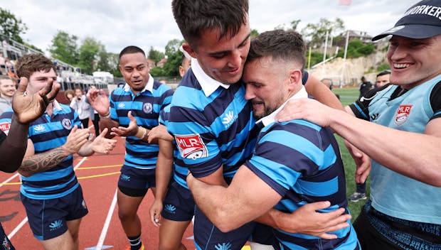 MOUNT VERNON, NEW YORK - JUNE 04: Dylan Fawsitt #2 of Rugby New York is hugged by Charlie Hewitt #19 after he was recognized for his 75th career Major League Rugby appearance after the match against the Dallas Jackals at Memorial Field on June 04, 2023 in Mount Vernon, New York. (Photo by